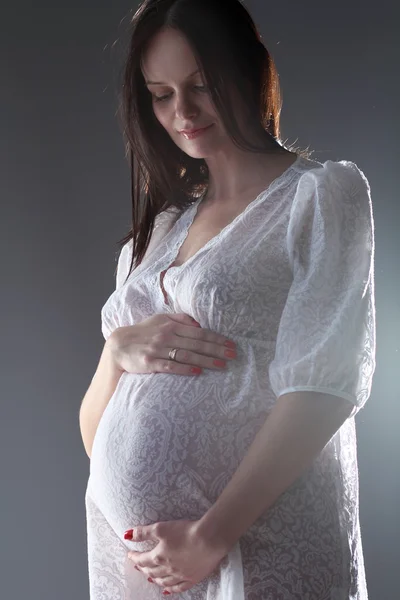 Pregnant female holding her breasts — Stock Photo, Image