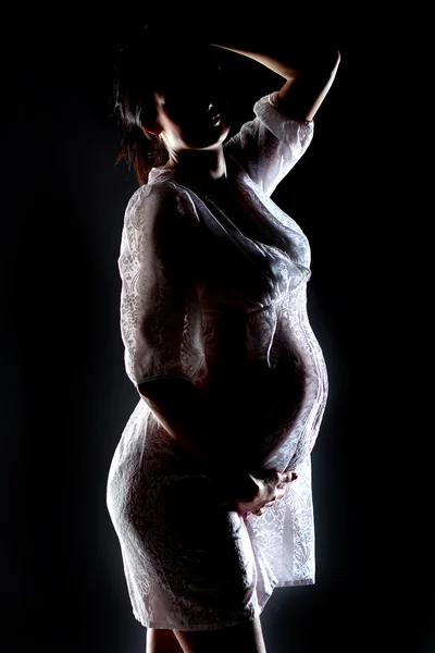 Femme enceinte tenant ses seins — Photo