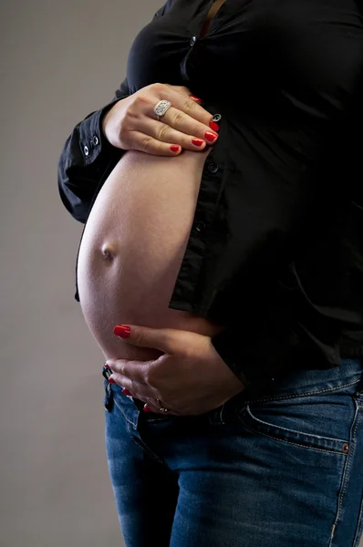Pregnant woman holding her tummy — Stock Photo, Image
