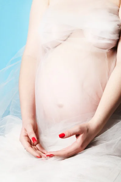 Schöne schwangere Frau in weißem Chiffonschal — Stockfoto