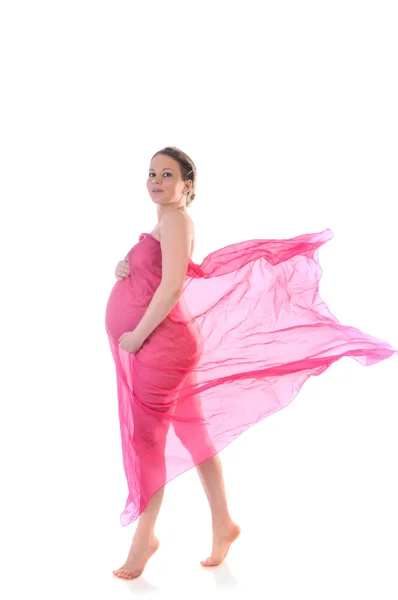 Beautiful pregnant young woman in pink blowing dress — Stock Photo, Image