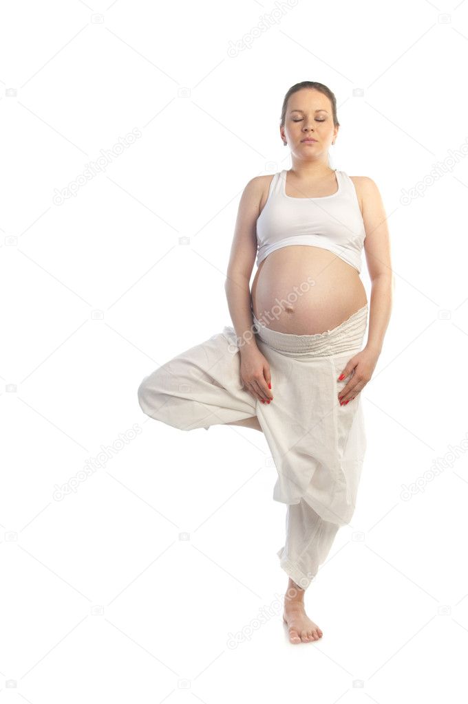 Beautiful pregnant woman doing yoga exercise.