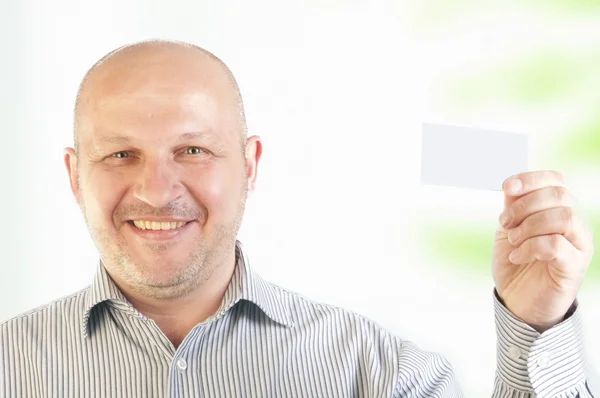 Affärsman som innehar ett tomt visitkort — Stockfoto