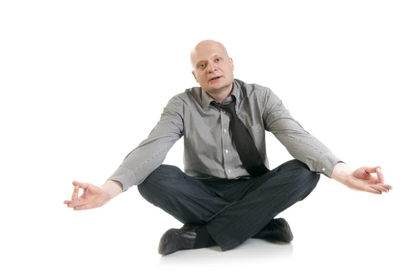 Businessman meditating in lotus position — Stock Photo, Image