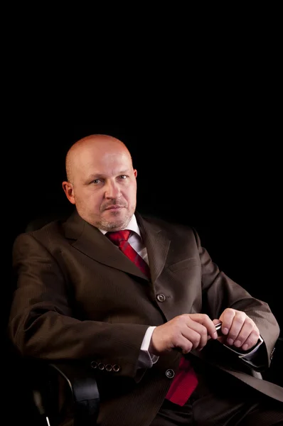 Serious businessman on black background — Stock Photo, Image