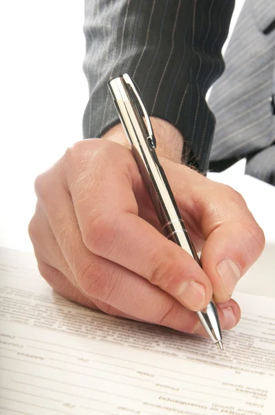 Human hand with pen makes signature — Stock Photo, Image