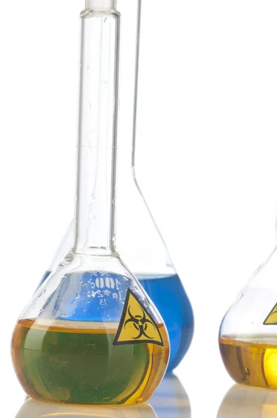 Glass laboratory equipment with symbol biohazard — Stock Photo, Image