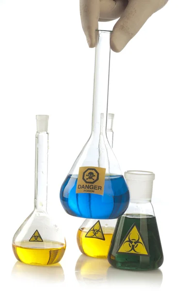 Glass laboratory equipment with symbol biohazard and danger — Stock Photo, Image