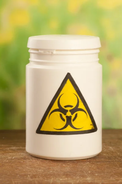 Jar of medications with symbol biohazard. — Stock Photo, Image