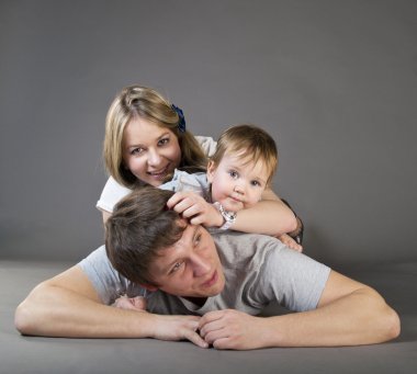 Excited, happy young family in a joyful huddle clipart