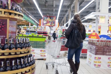 Young woman shopping at supermarket clipart