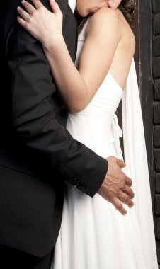 Bride and Grooms arm round her waist clipart