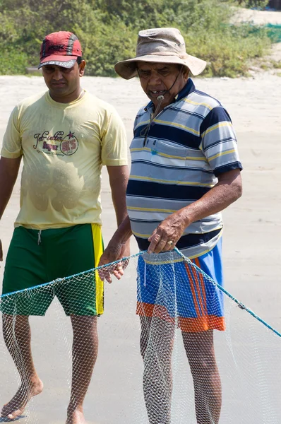 Fishing with net on the beach — Stock Photo, Image