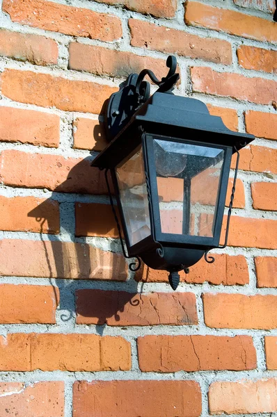 Lanterna forjado em uma parede de tijolo — Fotografia de Stock