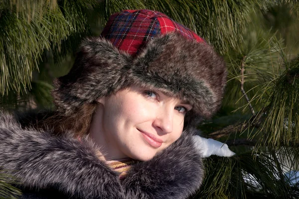 Womans portrait in a fur tree — Stock Photo, Image