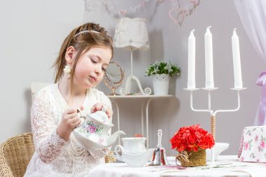 A beautiful little girl having a tea party clipart