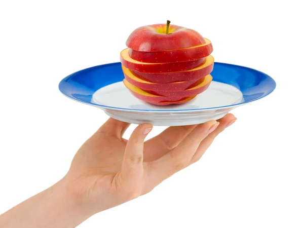 Mão com prato e maçã picada — Fotografia de Stock