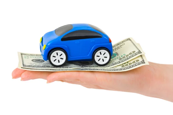 Mão com dinheiro e carro de brinquedo — Fotografia de Stock