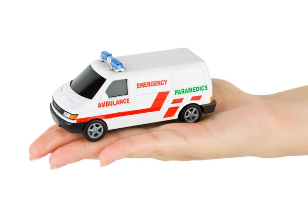 Рука з іграшковим автомобілем швидкої допомоги — стокове фото