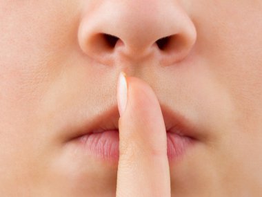 Woman holding finger to lips clipart