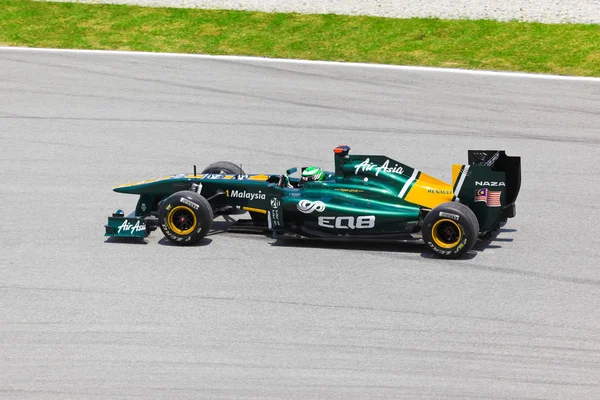 SEPANG, MALAYSIA - APRIL 8: Heikki Kovalainen (hold Lotus) på fi - Stock-foto