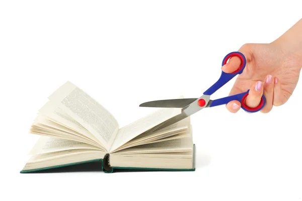 Hand with scissors cutting book — Stock Photo, Image