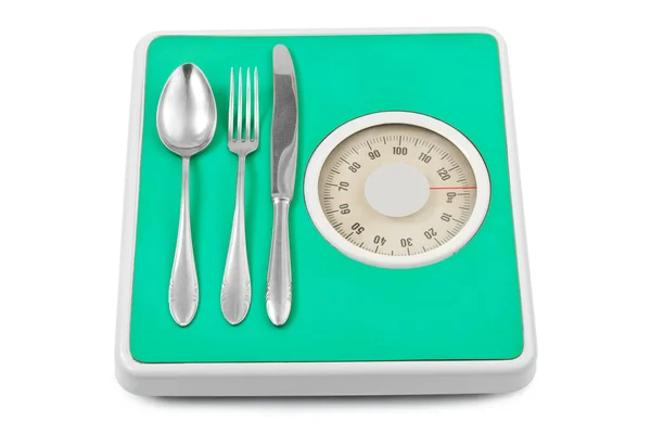 Πιρούνι και κουτάλι σε κλίμακα βάρους — Φωτογραφία Αρχείου
