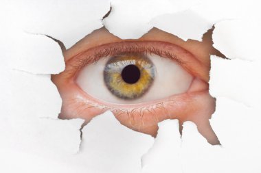 Eye looking through hole on paper clipart