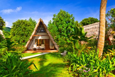 Bungalow in hotel at tropical beach clipart