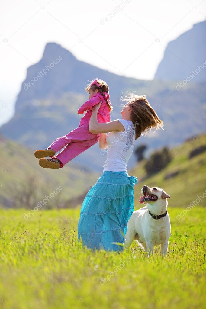 Happy family walking with dog