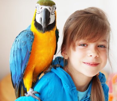 Child with ara parrot clipart