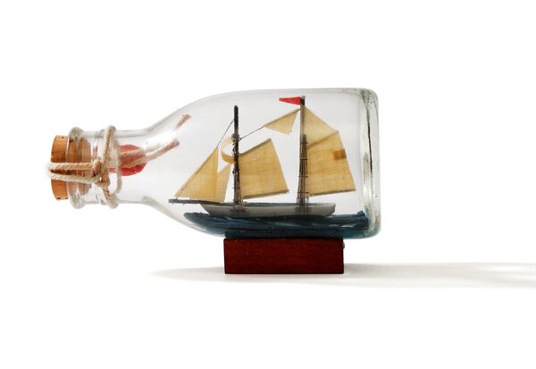 Two-masted ship in a bottle isolated