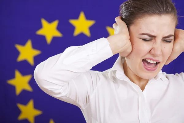 Frustrated woman screaming over european flag — Stock Photo, Image