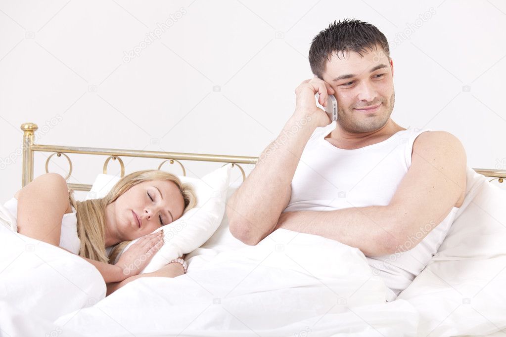 Man cheating while woman sleeping