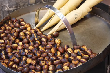 Roasted colorful chestnuts in street cafe clipart