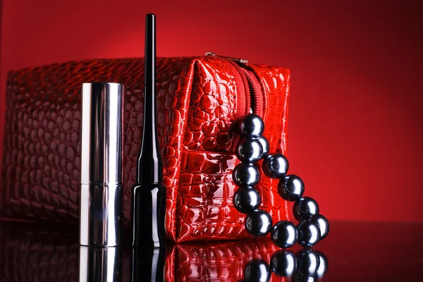 Red bag for makeup and lipstick and mascara. — Stock Photo, Image