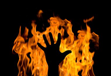 Man's hand against the fire. gesture of support clipart