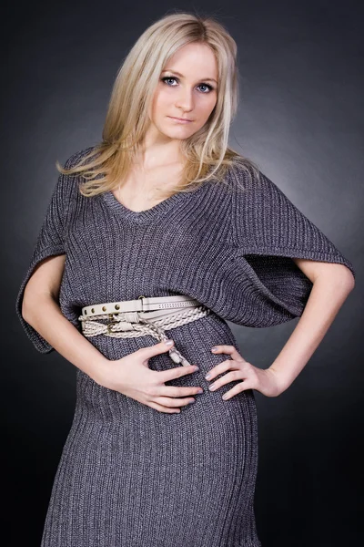 stock image Portrait of a pretty woman in a gray jersey dress