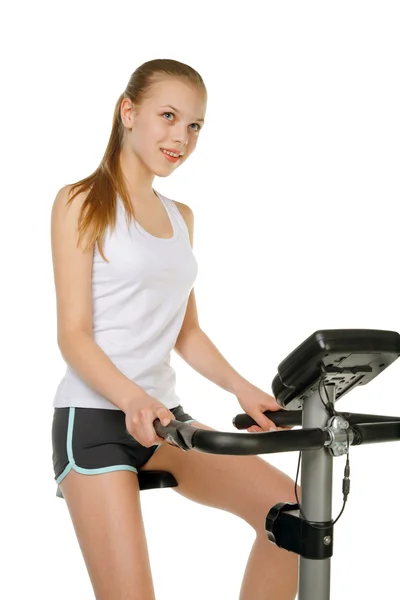 Menina com bicicleta de ginásio — Fotografia de Stock