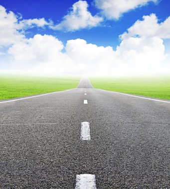 Green field and road over blue sky clipart