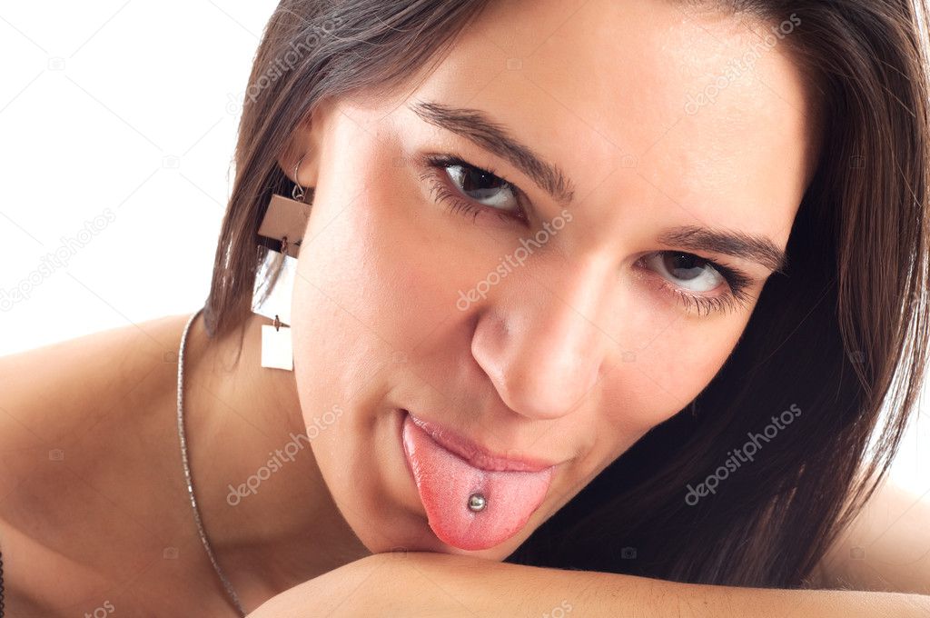 Young woman showing het tongue with piercing isolated on white b