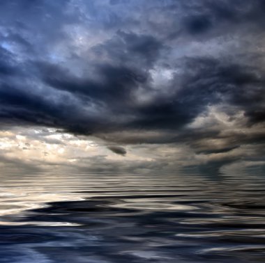 Dark cloudy stormy sky with clouds and waves in the sea - global clipart