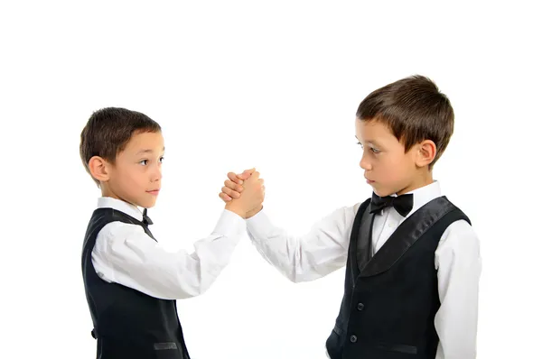 Twins playing arm wrestling isolated — Stock Photo, Image