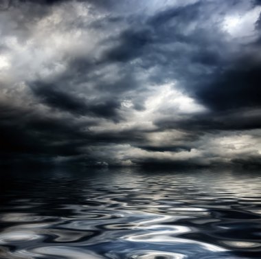 Dark cloudy stormy sky with clouds and waves in the sea clipart