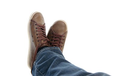 Male legs in sneakers and jeans lying clipart