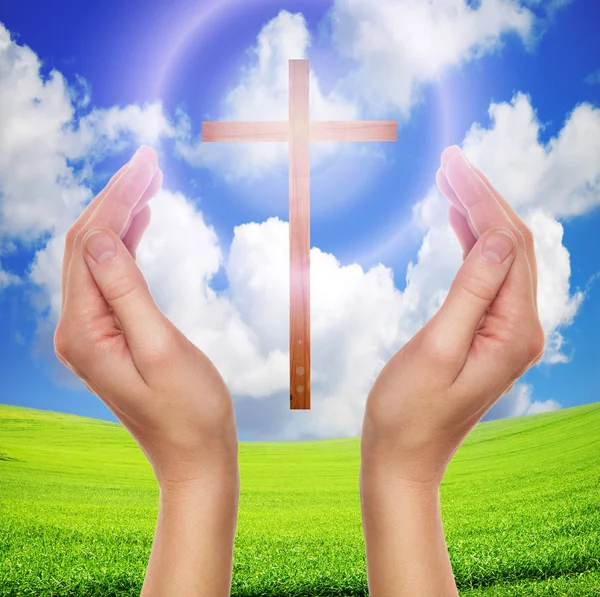 Hands praying with cross in sky - easter concept — Stock Photo, Image