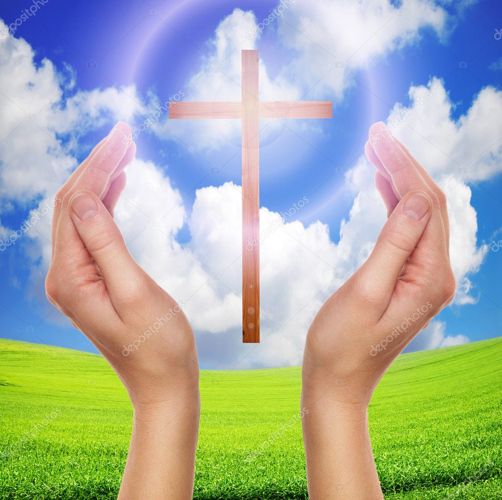Hands praying with cross in sky - easter concept
