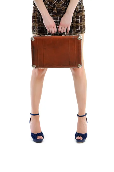 Female legs with hands holding vintage case — Stock Photo, Image