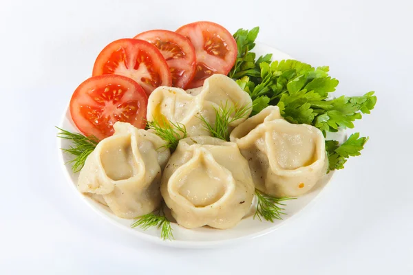 stock image Tasty hinkali with tomato and salad