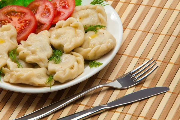 stock image Tasty ravioli with tomato and salad